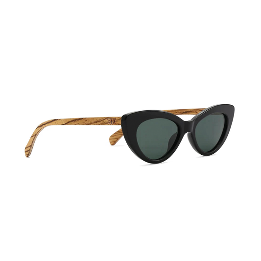 This is an iconic slim cat eye sunglass from Australian brand Soek that never goes out of style. Favoured by style icons for generations, our Savannah is finished in classic black with walnut wood arms and fitted with Khaki lenses or clear blush pink with walnut wooden arms and fitted with gradient brown lenses.