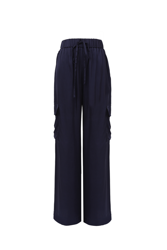 The Nouma trouser from FRNCH is a great summer piece in a silky feel fabric. A pull on trouser with an elasticated waist and tie belt. A wide leg trouser with patch pockets on the side ( cargo style ) . The fit is true to size.