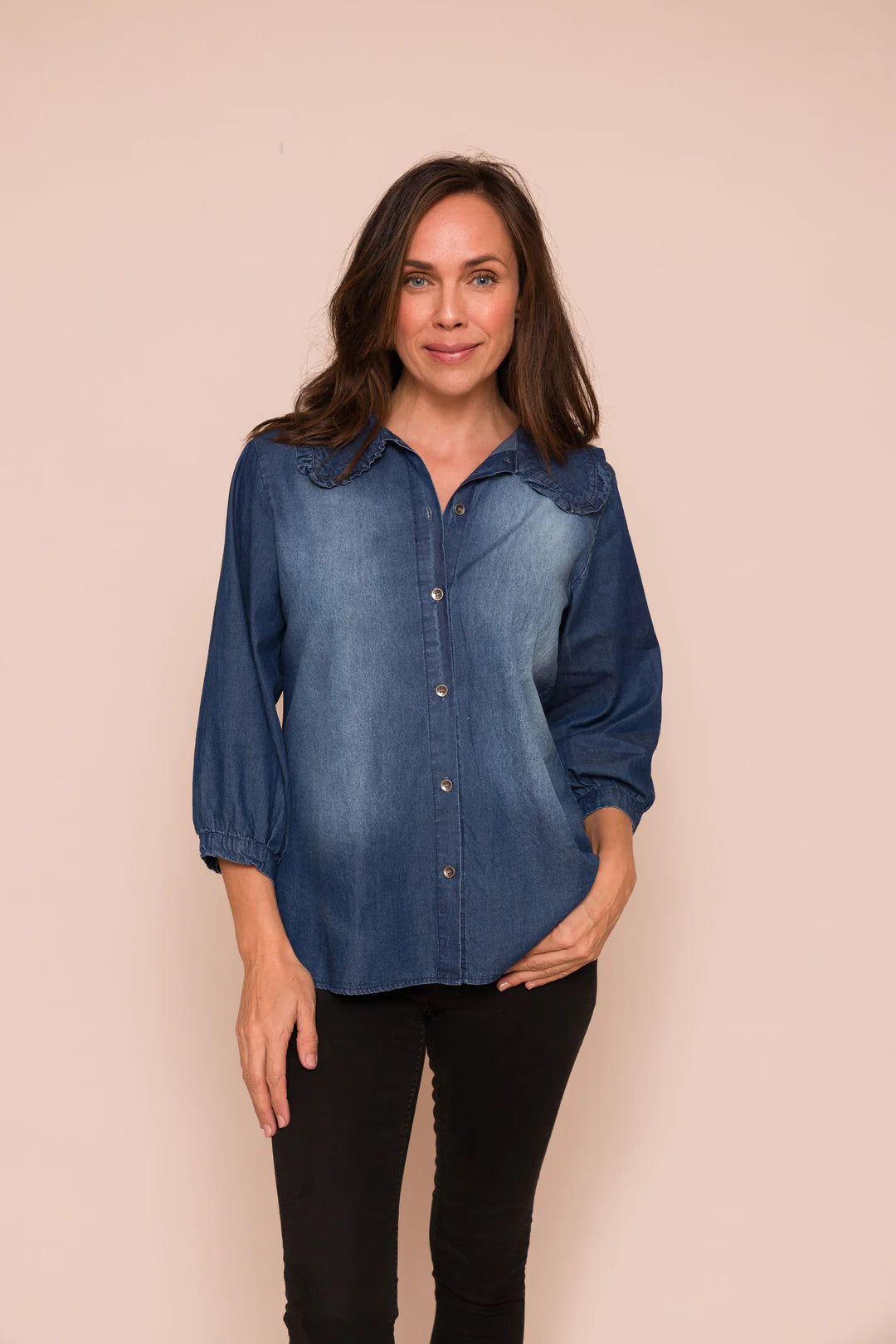 We all love a denim shirt ! This gorgeous piece by British brand Suzyd is a stunner. With a bracelet length sleeve with single button fastener at the cuff. The collar is rounded with a delicate denim frill. There is shading on the front and metallic buttons from the neck to the hem. It is true to size.