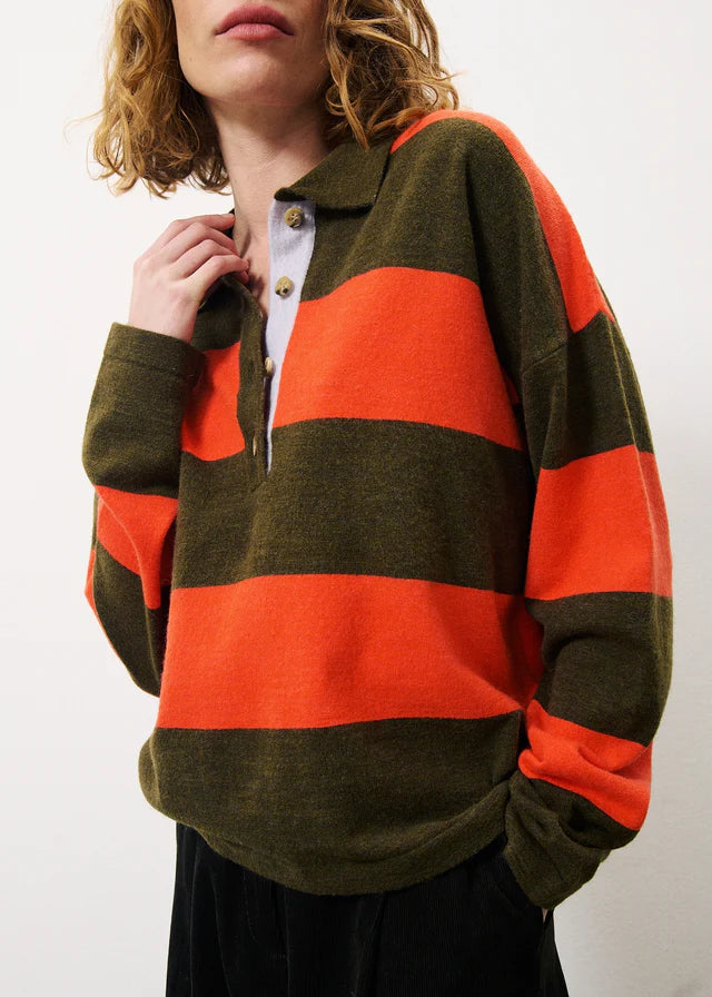 A great lighter weight knit form Parisian brand FRNCH. The bold combination of coloured stripes makes this a statement piece. It has a collar and button front with contrast buttons. The long sleeves have a ribbed cuff. The hem is straight and the fit is generous and boxy.