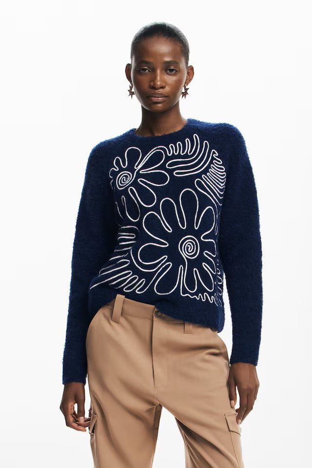 Another great knit from Spanish brand DESIGUAL in a gorgeous thicker and textured fabric. This boxy style knit has a distinctive floral and abstract print on the front . The design is made with a white ribbon. The fit is true to size.