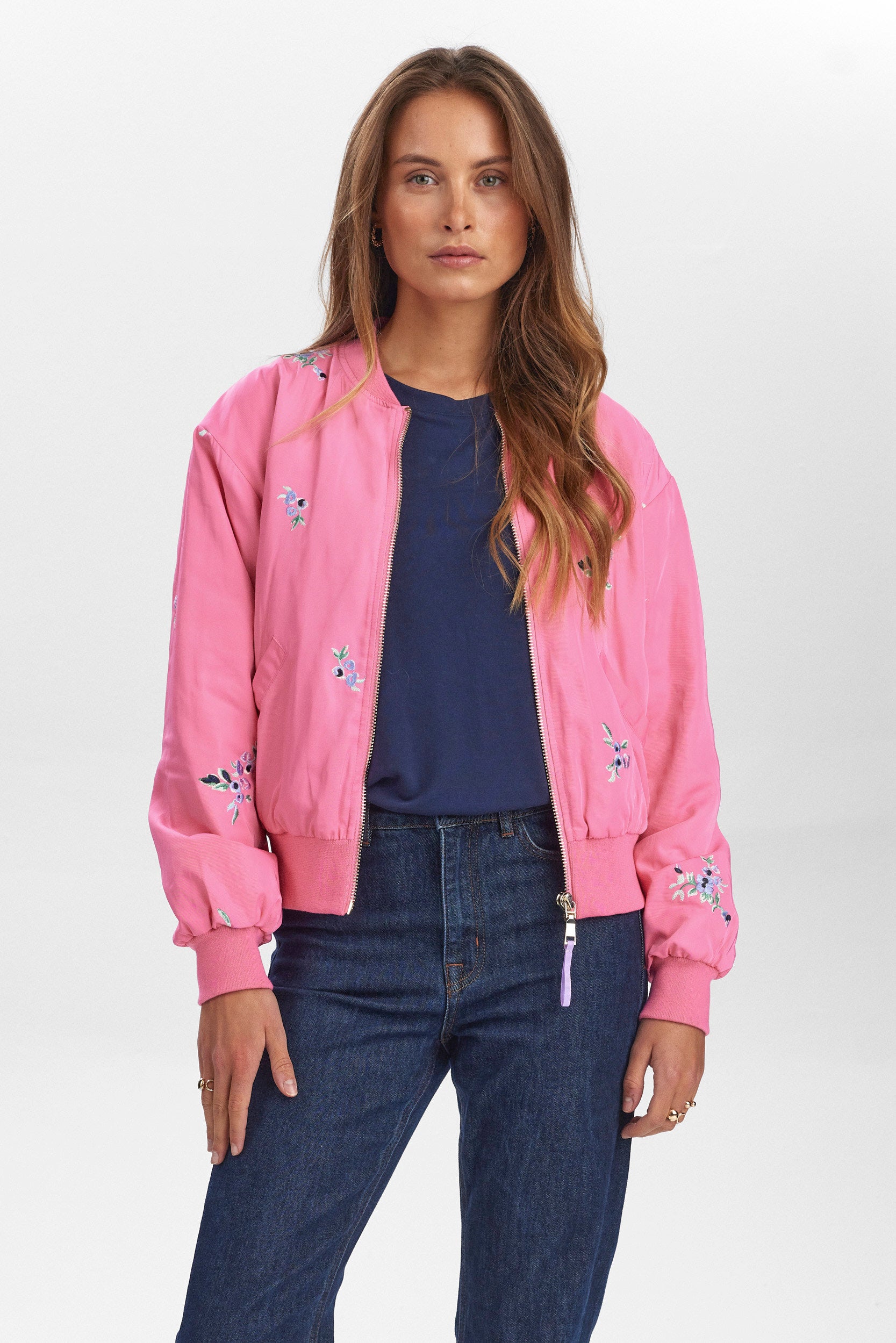 An eye catching bomber style jacket from Scandi brand NUMPH in a vibrant pink with a ribbed collar and cuffs. The pretty floral embroidery adds a touch of freshness. The inside is quilted and warm.