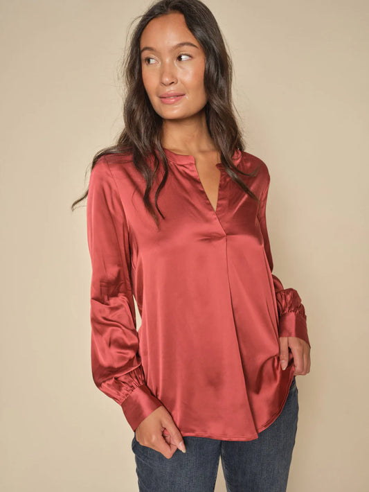 This satin blouse from Scandi brand Mos Mosh is inspired by the nostalgic 70s. It has a loose silhouette and is designed with a trendy V neck, billowy sleeves, collar, and buttoned cuffs. We think it looks amazing with everything from tailoring to skirts and jeans. The fit is true to size