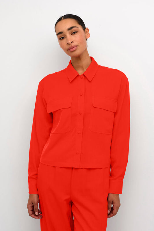 This stunning shirt from Scandi brand Kaffe is a complete show stopper of a piece. This vibrant red is super on trend for the season. It is a boxy shape with a straight hem. There is a shirt style collar and two breast pockets. It buttons at the front with fabric coloured buttons. Such a beautiful piece. The boxy fit is true to size.