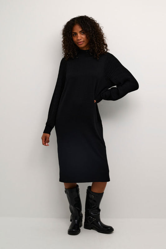 A beautiful knitted dress from Scandi brand Kaffe in the softest of fabrics. A straight shaped dress with a turtle neck. The sleeves are cable knit to give this dress a sophisticated look. A very easy to wear stand out piece to wear with chunky boots or heels for this coming winter season. The fit is true to size.