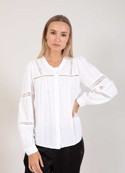 This shirt for Coster Copenhagen is adorned with small lace details that adds a subtle and delicate look. These details are placed in deliberate places on the shirt, creating a beautiful and feminine look. A hidden button placket provides a clean and minimalist look while ensuring a seamless finish. The fit is generous.