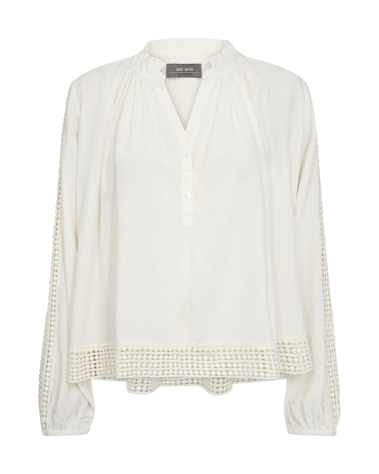 Embrace boho vibes with this flattering blouse from Scandi brand Mos Mosh. Crafted in a loose A-shape silhouette, it features a buttoned V-neck and delicate ruffle accents for a feminine touch. Adorned with intricate lace trim on the sleeves and bottom hem, it exudes charm. Complete the '70s-inspired boho vibe by pairing it with flare jeans for a perfectly balanced look.