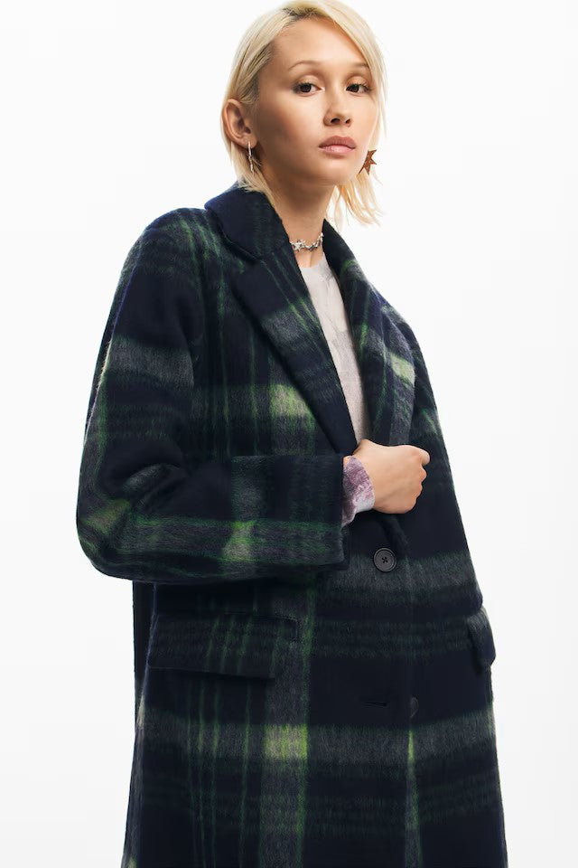 What's not to love with this coat from Spanish brand DESIGUAL ? This stunning coat with a V neck and collar has long simple sleeves. It closes with two navy buttons and is in a fabulous Navy and green plaid fabric. It is fully lined and has two front pockets with flaps.