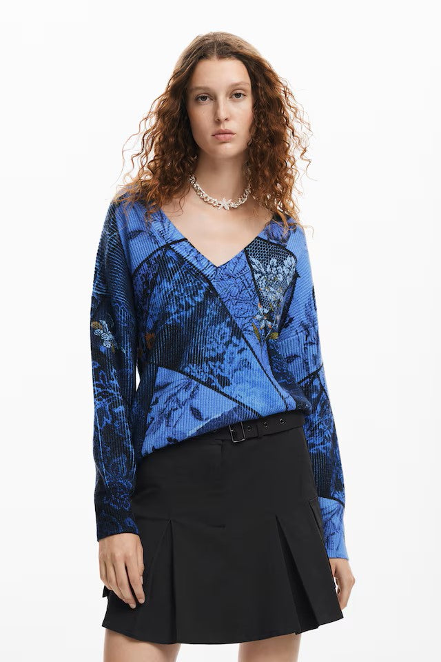 The Ocean jumper from Spanish brand DESIGUAL is a statement piece. This loose V neck ribbed knit has a deep V with a ribbed trim, long sleeves with ribbed cuffs and a straight ribbed hem. The The print is in shades of blue and black with a dash of orange. A great casual slouchy look. The fit is true to size.