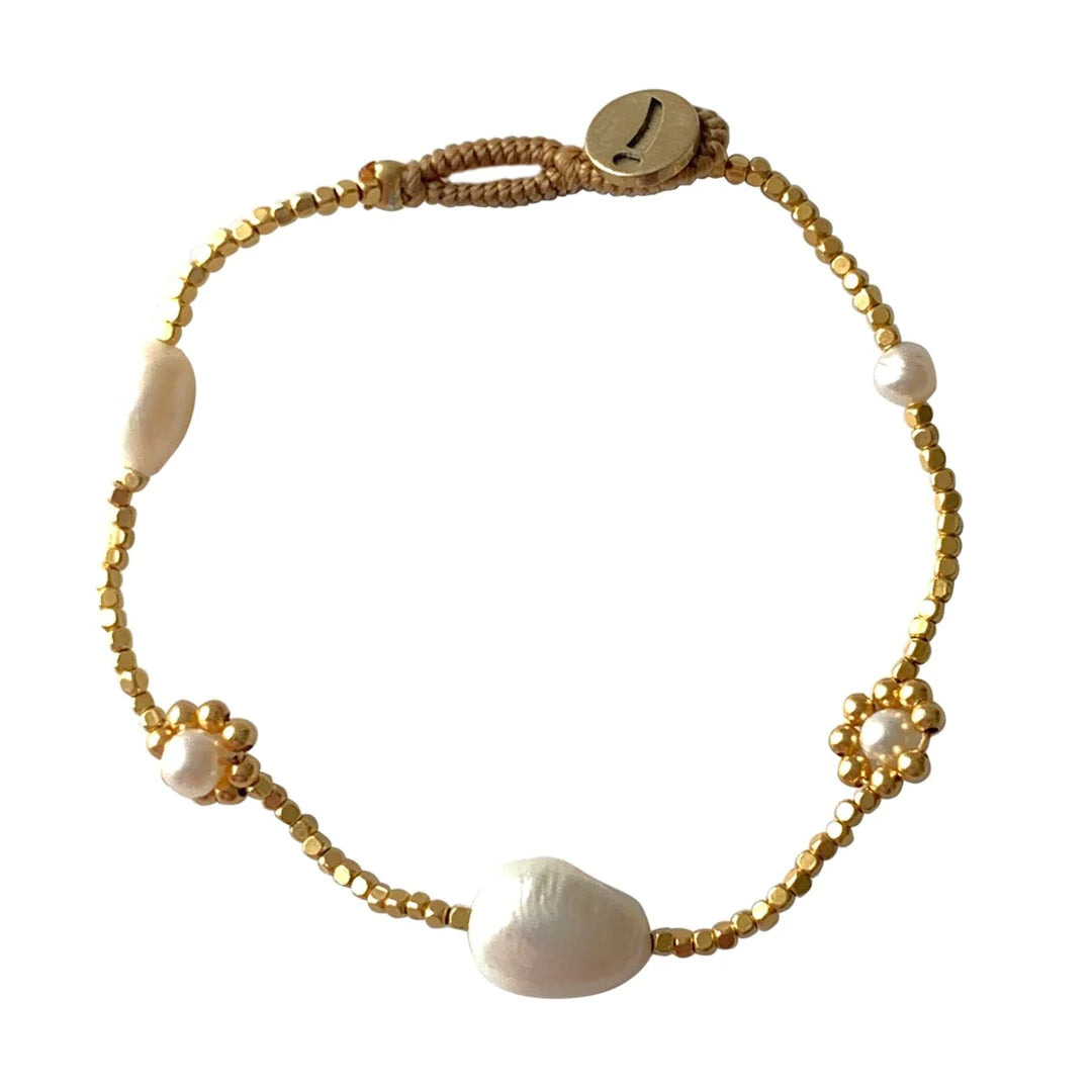 A collection of tiny beautiful 14k gold plated irregular beads with stunning freshwater pearls. The combination is so pretty and classic and is the perfect combination of modern style and vintage feel.