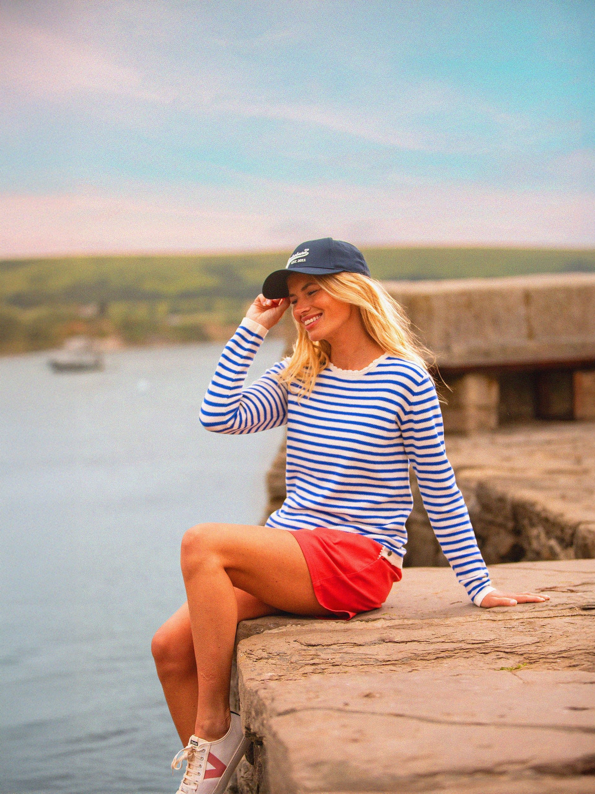 This vibrant blue and white striped jumper from BRAKEBURN is a playful and easy addition to any casual outfit. With a soft, lightweight knit that keeps you warm in a breeze and a scalloped neckline that adds a touch of charm, this jumper is ideal for layering.