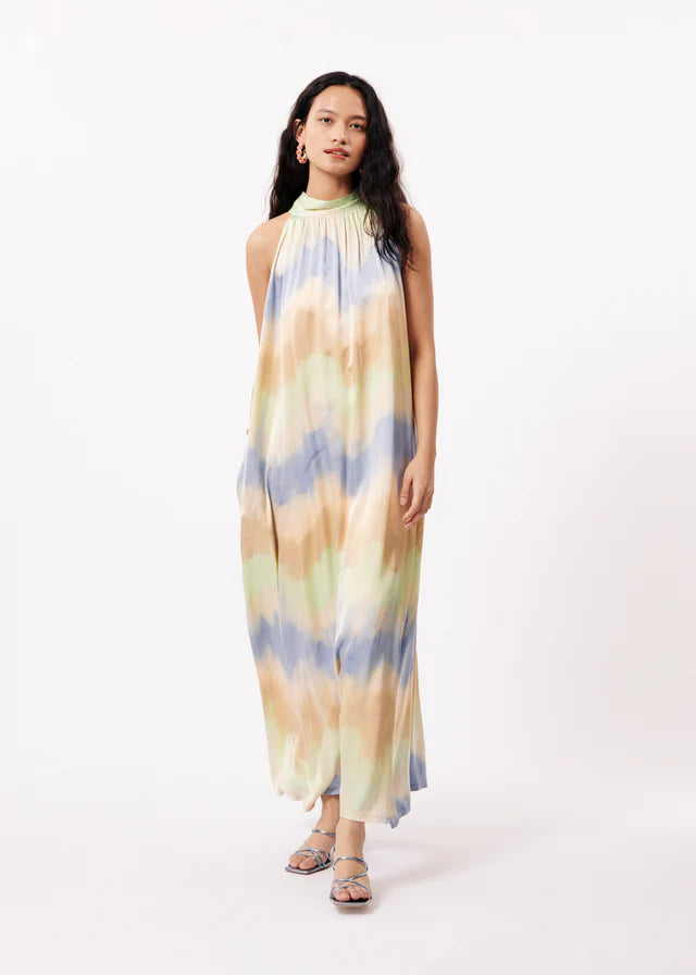Transport yourself to the height of summer elegance with the Auberya Dress from FRNCH. Crafted in a luxurious silky fabric, this maxi dress features a flattering tubular silhouette and playful cutaway shoulders adorned with a sizable bow. Perfect for any occasion, from weddings to casual days out - simply pair with a platform trainer for a touch of effortless chic. Sizing is true to fit for your ultimate style and comfort.