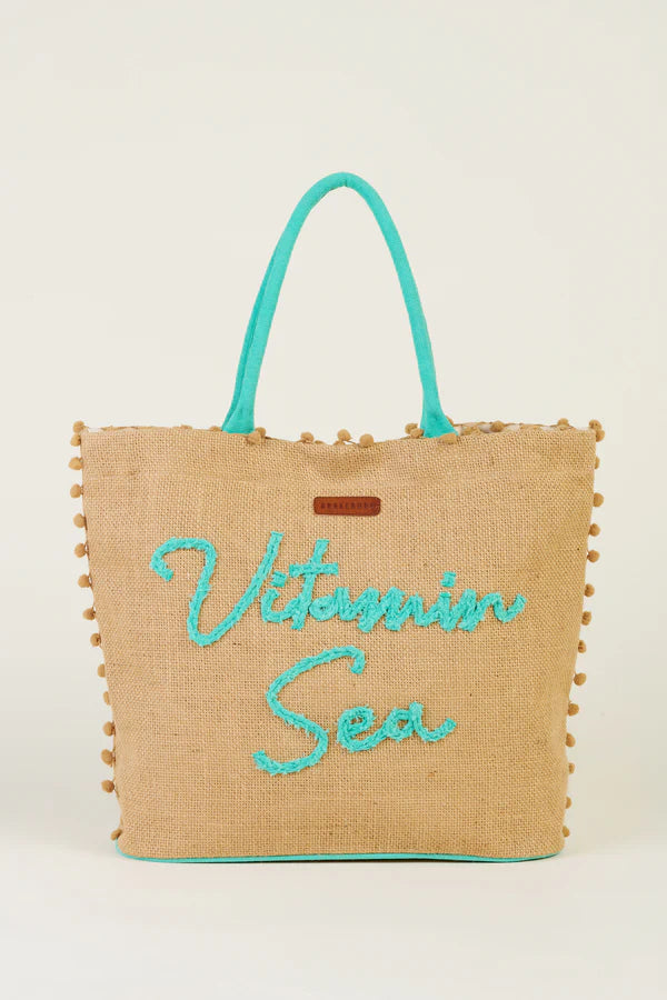 Get a healthy dose of Vitamin Sea with this fun jute beach bag by Brakeburn. Corded rope handles, magnetic fastening and an internal zip pocket bring the practicality, while the pom pom trim and ‘Vitamin Sea’ plaited slogan keep it fresh and laidback.