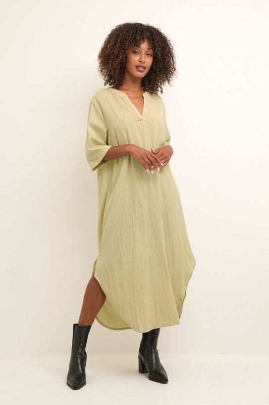 notch neck linen dress with side splits. Easy to wear beach to bar. Fits true to size